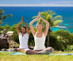 Smiling men and women do yoga together Stock Photo