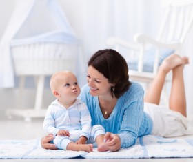 Smiling mother looking pouting baby Stock Photo