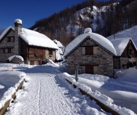 Snow-covered stone huts Stock Photo