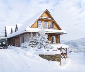 Snow covered villas with cars Stock Photo