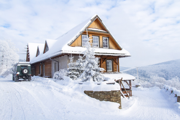 Snow covered villas with cars Stock Photo