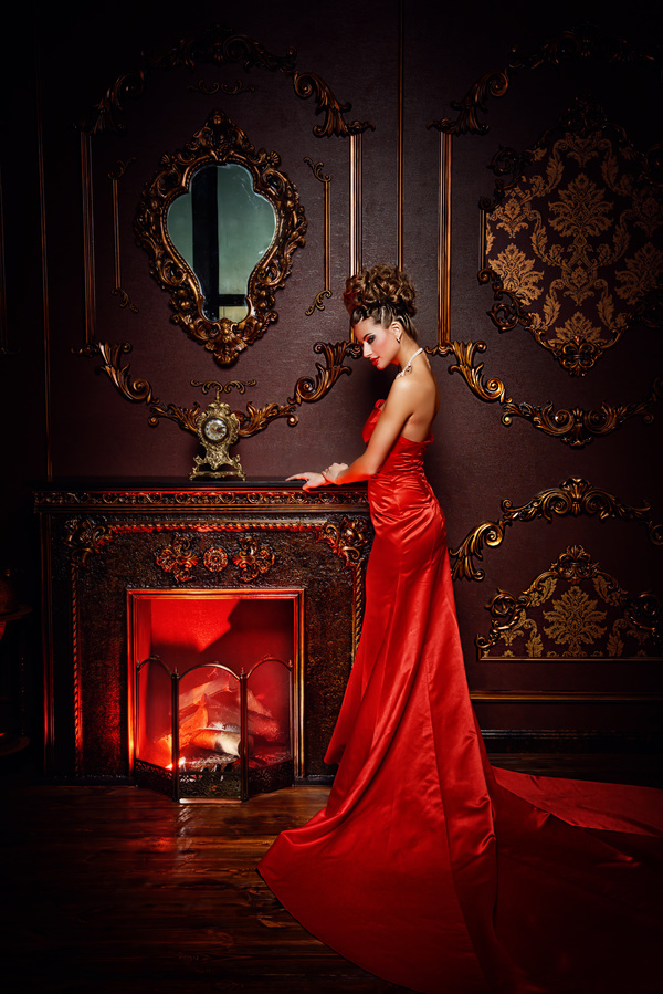 Standing in front of the fireplace red dress woman Stock Photo 02