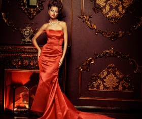 Standing in front of the fireplace red dress woman Stock Photo 03