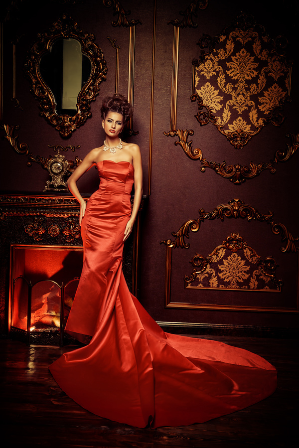 Standing in front of the fireplace red dress woman Stock Photo 03