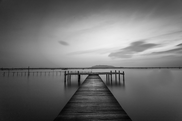 Sunset at the wooden dock black and white photo