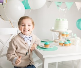 The little boy at the birthday table Stock Photo