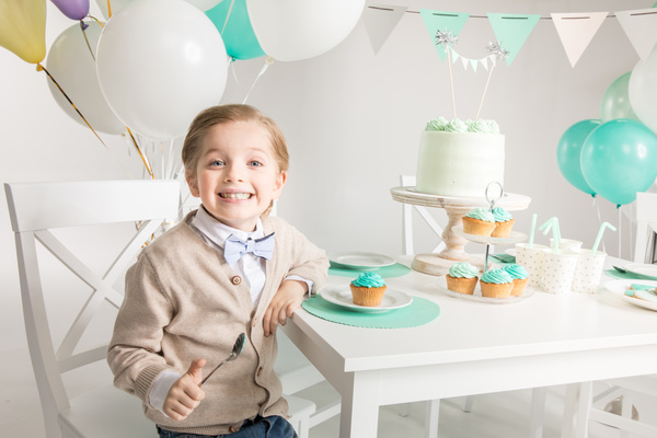 The little boy at the birthday table Stock Photo