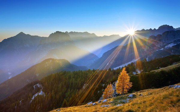 The sun between the mountains Stock Photo