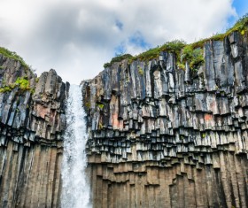 The waterfall on the steep cliff Stock Photo