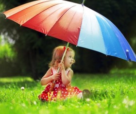 Umbrella little girl on the grass Stock Photo