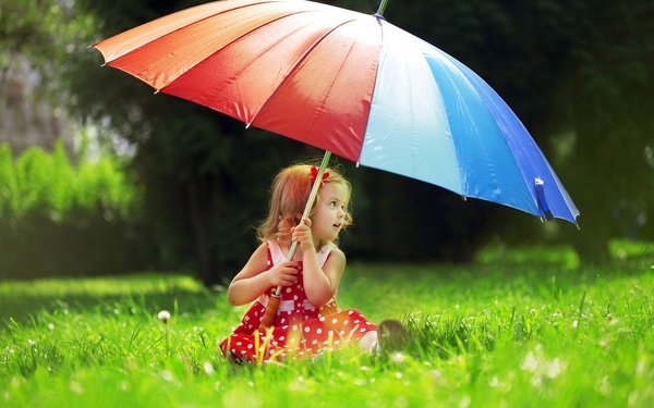 Umbrella little girl on the grass Stock Photo
