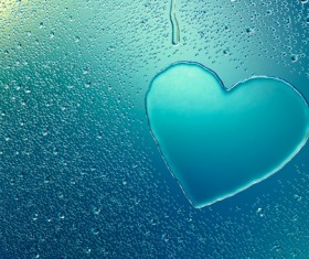 Water droplets on glass window with heart Stock Photo