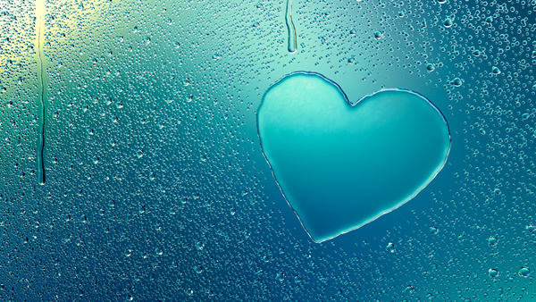Water droplets on glass window with heart Stock Photo