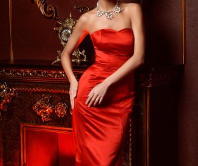Woman wearing a red dress with jewelry necklace Stock Photo