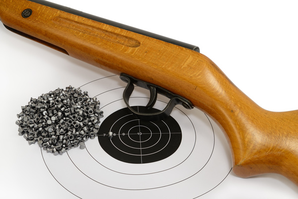Air gun bullets and target paper Stock Photo