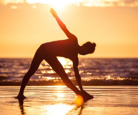 Backlight shooting sunrise beach practicing yoga woman Stock Photo 01