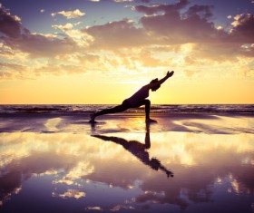 Backlight shooting sunrise beach practicing yoga woman Stock Photo 02