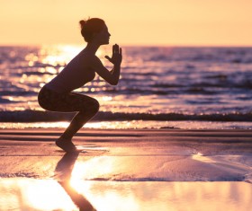 Backlight shooting sunrise beach practicing yoga woman Stock Photo 08