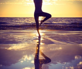 Backlight shooting sunrise beach practicing yoga woman Stock Photo 10