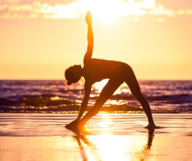 Backlight shooting sunrise beach practicing yoga woman Stock Photo 11