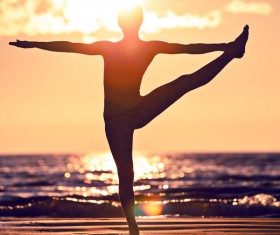 Backlight shooting sunrise beach practicing yoga woman Stock Photo 12
