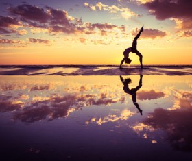 Backlight shooting sunrise beach practicing yoga woman Stock Photo 13
