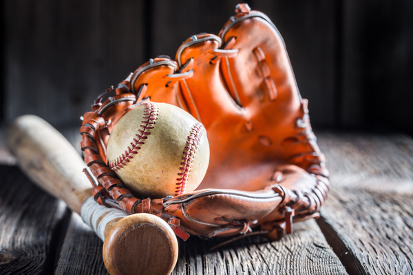 Baseball glove and a baseball bat Stock Photo