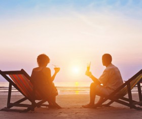 Beach couple watching sunset HD picture