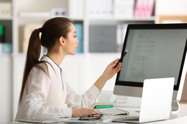 Check the programming result of the female programmer Stock Photo