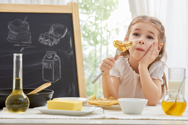 Children who eat delicious pancakes Stock Photo