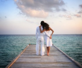 Couple looking at the sea back Stock Photo