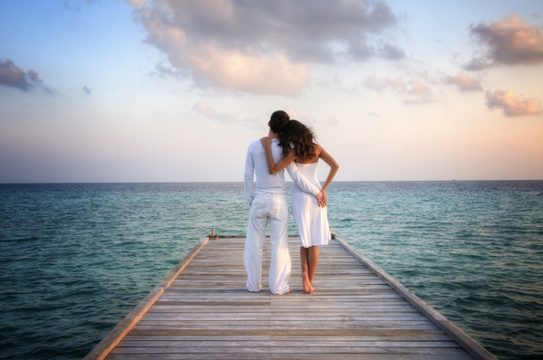Couple looking at the sea back Stock Photo free download