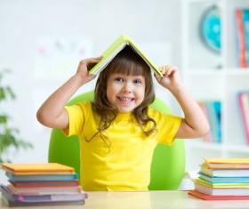 Cover a child with a book on the head Stock Photo