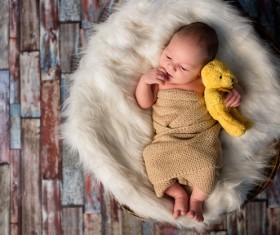 Cute baby holding a teddy bear HD picture