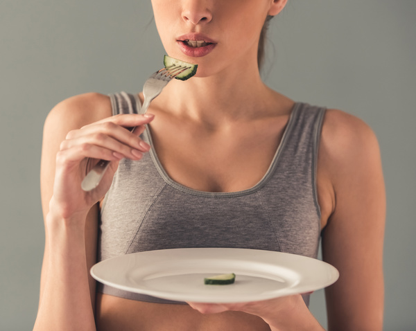 Eat cucumber to lose weight of a woman Stock Photo