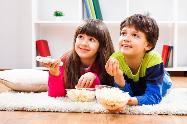 Eat popcorn to watch TV children Stock Photo