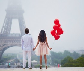 Eiffel Tower in front of a couple holding hands HD picture