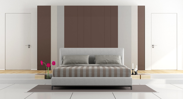 Elegant bedroom with bedside flower arrangement Stock Photo