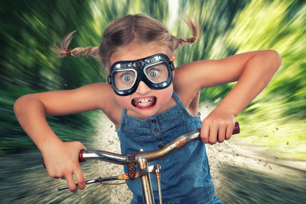 Funny face of child cyclists Stock Photo