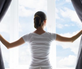 Girls open the curtains Stock Photo