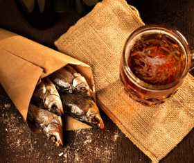 Grilled fish with a beer on a black background Stock Photo