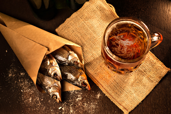 Grilled fish with a beer on a black background Stock Photo