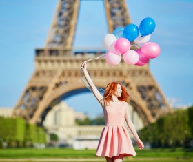 Holding a balloon young girl with the Eiffel Tower background HD picture