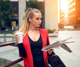 Holding a newspaper and coffee girl HD picture