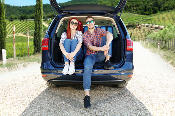 Husband and wife sitting in the back of the car Stock Photo