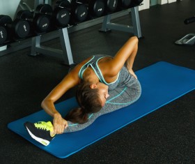 In the gym doing stretching exercises woman Stock Photo 05