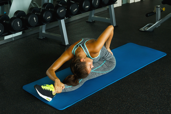 In the gym doing stretching exercises woman Stock Photo 05