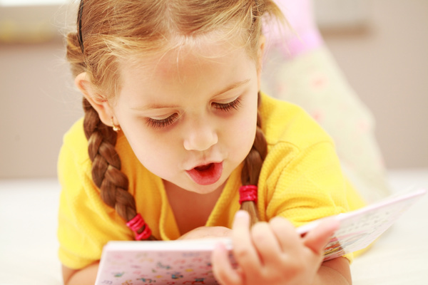 Little girl reading Stock Photo