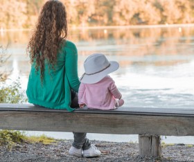 Mother and baby sitting on a bench to rest HD picture