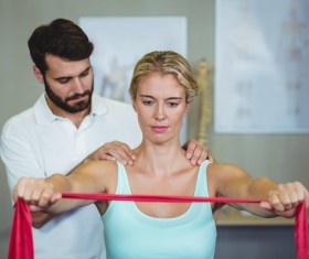 Rehabilitation division instructs female patient to exercise Stock Photo